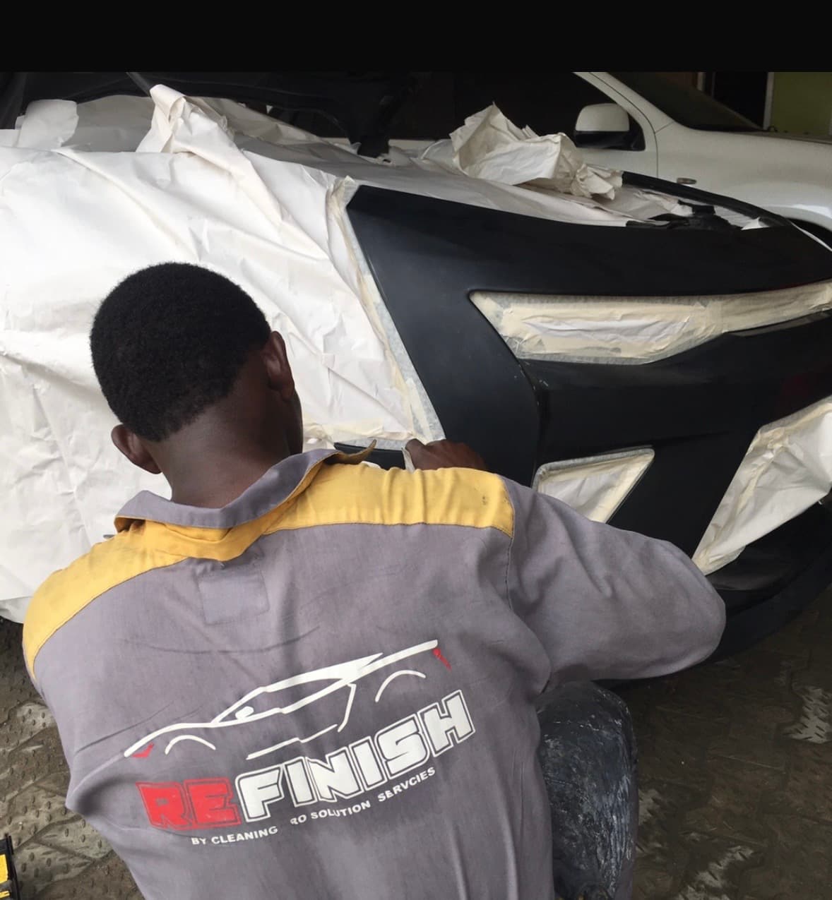 Refinish PHC technician at work on a vehicle